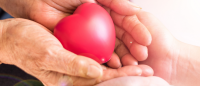 Hands holding heart.